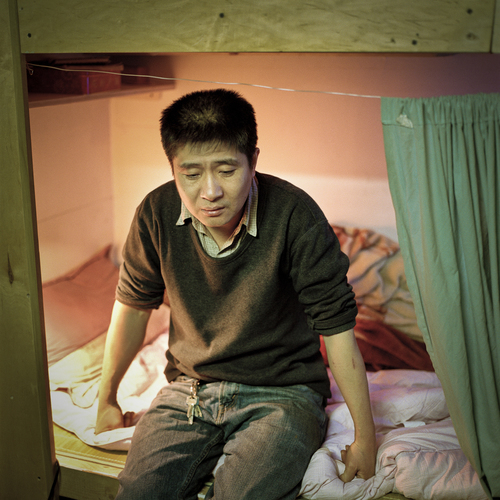 Mr. Chu, an immigrant laborer from China, once lived in cubicle #4 at 81 Bowery. Like many immigrant laborers, he lives on very little and sends most of his earnings back to his wife and children back in China. | Annie Ling