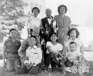 Pearl (standing L) with parents and siblings and other relatives at Queens College, 1953.