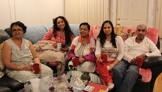 The Lal family spends a Sunday evening together gyaffing, watching the Miss USA pageant and drinking tea. From left to right: Caneza Ramon, Ashley Lal, Tatpati Lal, Rebena Lal and Mark Lal. Photo by Nadia Misir 