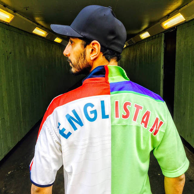 Riz Ahmed wearing his Englistan cricket jersey that mixes shirts from the 1992 World Cup-winning Pakistani cricket team and the England cricket shirt.